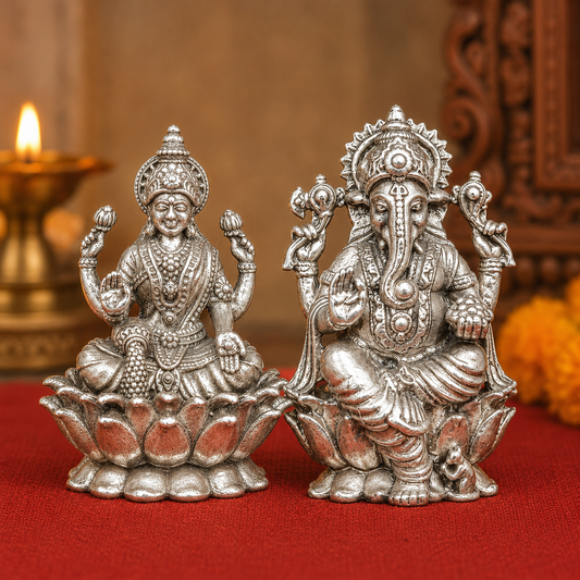 925 silver Lakshmi and Ganesha murti set seated on lotus and pedestal with warm festive background