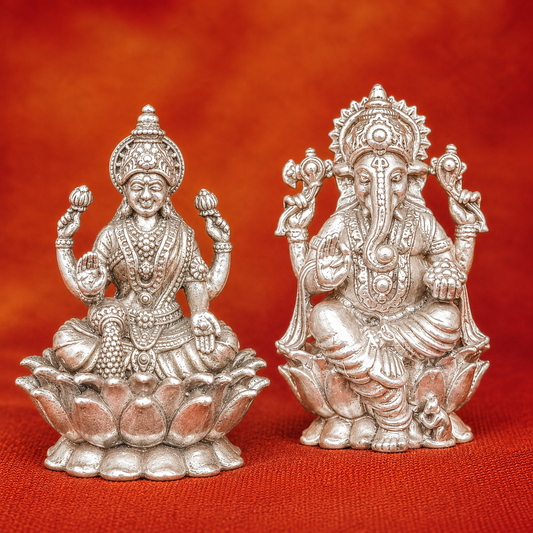 925 silver Lakshmi and Ganesha murti set on red fabric background with seated deity details