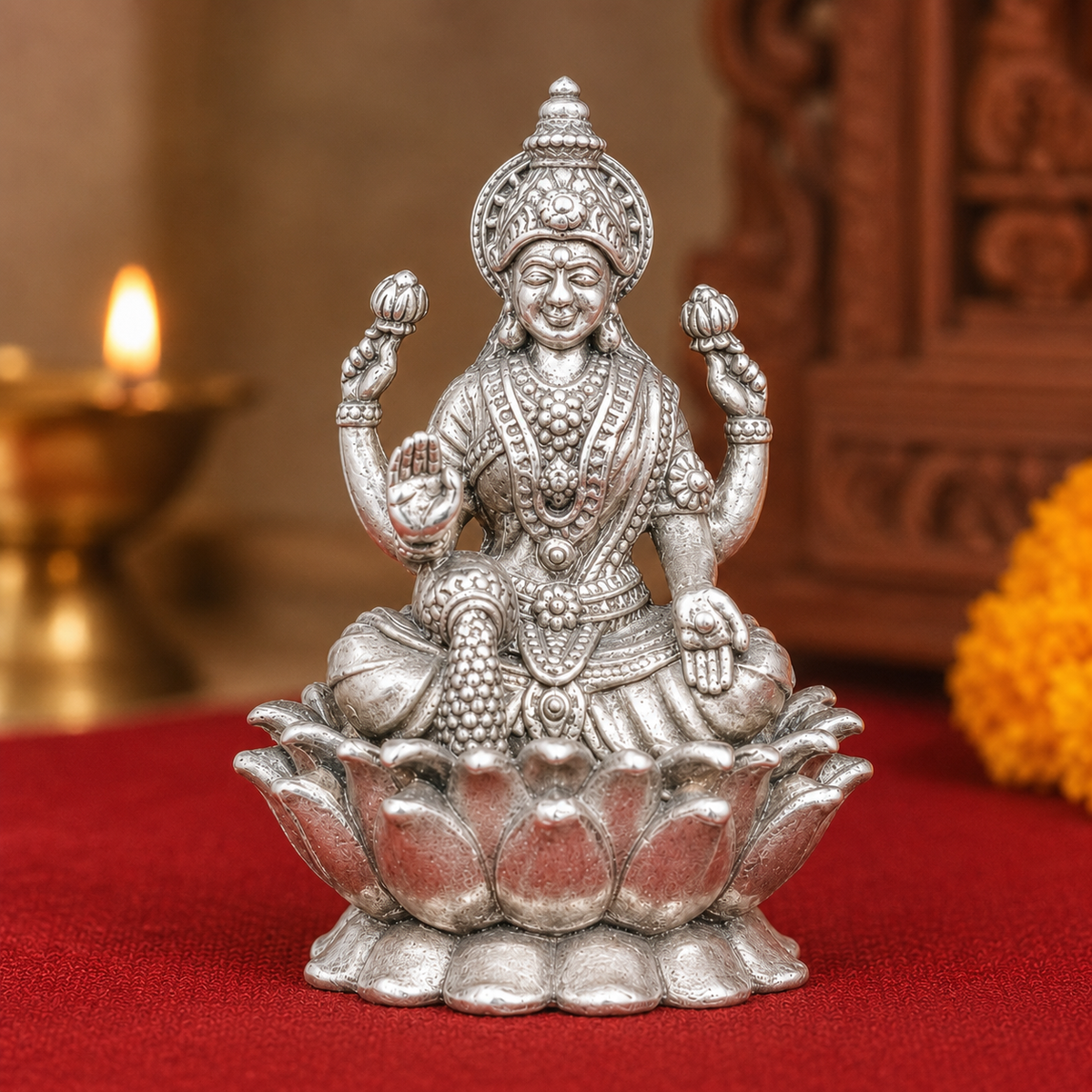 925 silver Lakshmi goddess murti with four arms seated on a lotus on red cloth