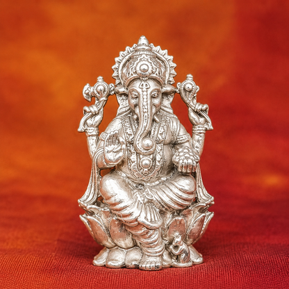925 silver Lord Ganesha murti seated with raised hands and detailed jewelry on red cloth