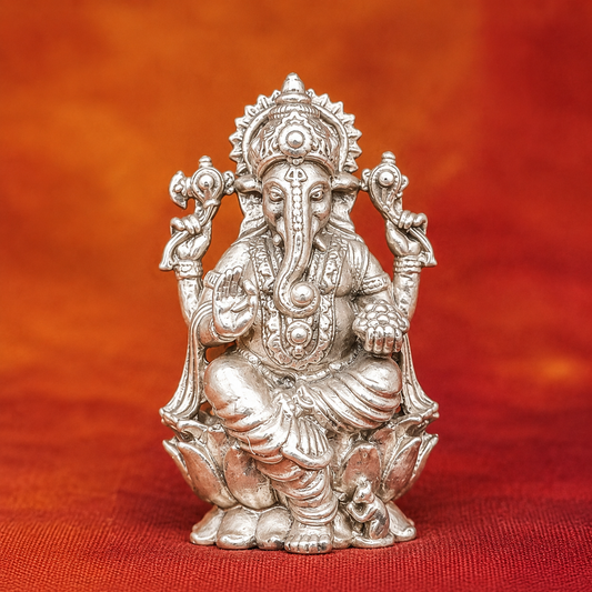 925 silver Lord Ganesha murti seated with raised hands and detailed jewelry on red cloth