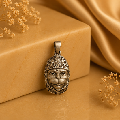 925 silver Lord Hanuman face pendant with loop bail, shown on a warm beige background