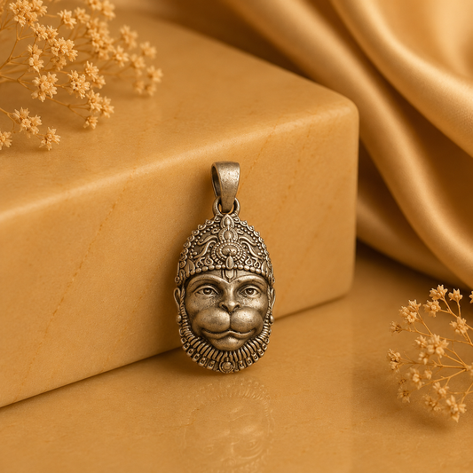 925 silver Lord Hanuman face pendant with loop bail, shown on a warm beige background