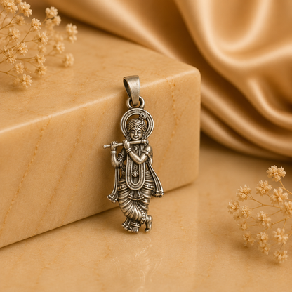 925 silver Lord Krishna murli pendant with fluted detail on a bail, shown on a stone background