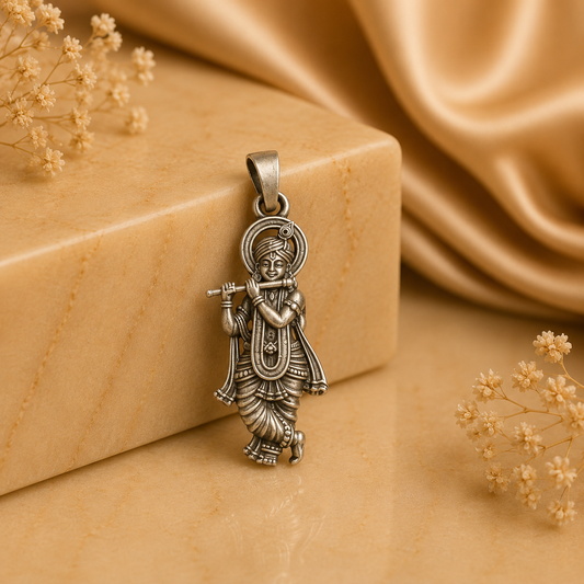 925 silver Lord Krishna murli pendant with fluted detail on a bail, shown on a stone background