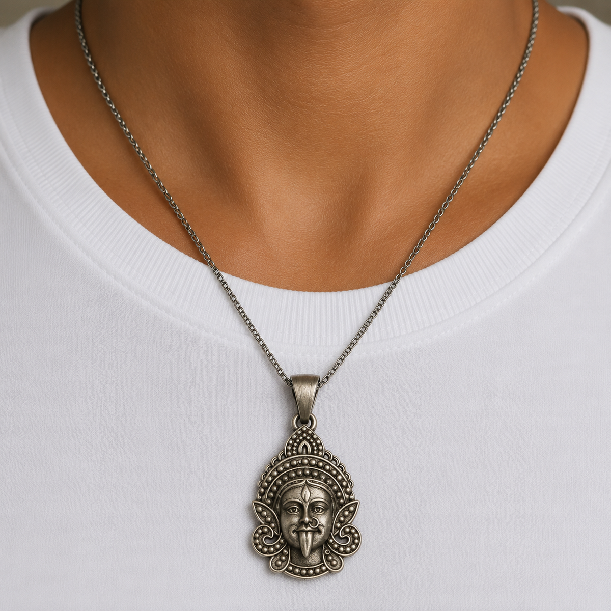 925 silver Maa Kali face pendant worn on a chain against a white shirt