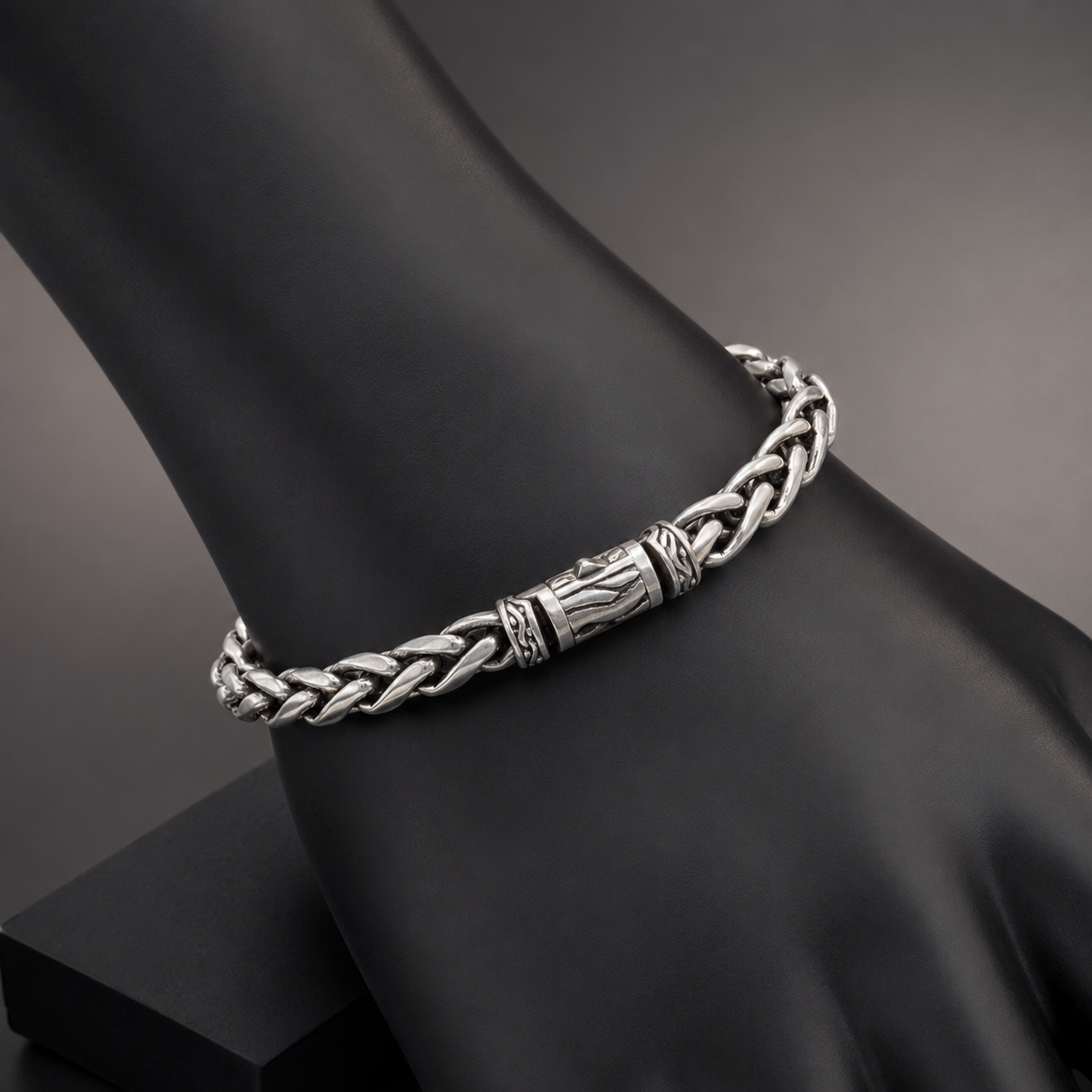 925 silver men’s braided bracelet worn on black display stand with engraved center links