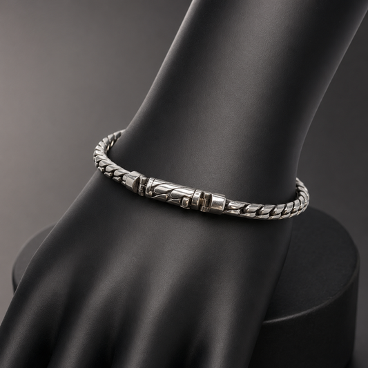 925 silver men’s twisted-link bracelet shown on a black display stand