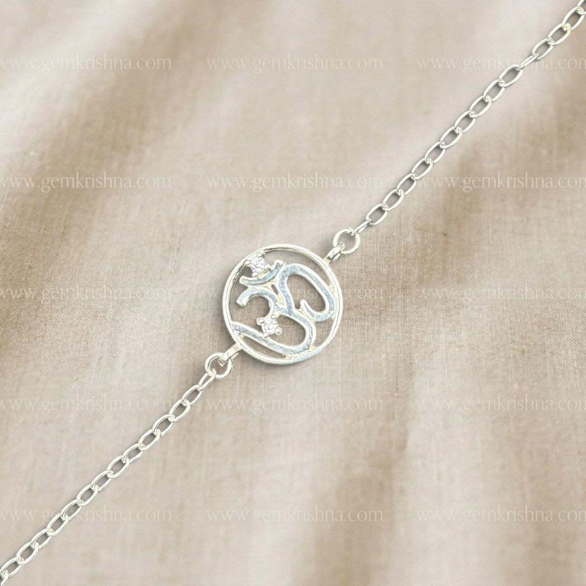 925 silver Om bracelet with blue enamel spiritual symbol and chain links on beige background