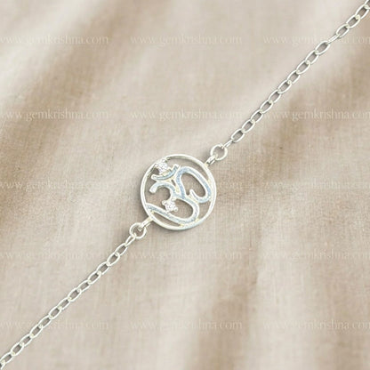 925 silver Om bracelet with blue enamel spiritual symbol and chain links on beige background