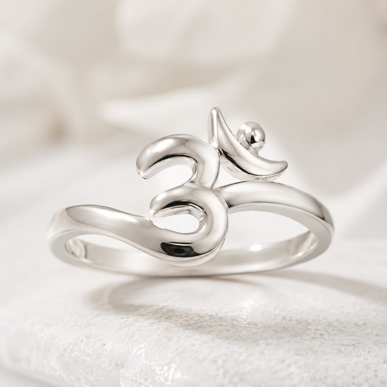 925 silver om symbol ring close-up on white studio background peace design