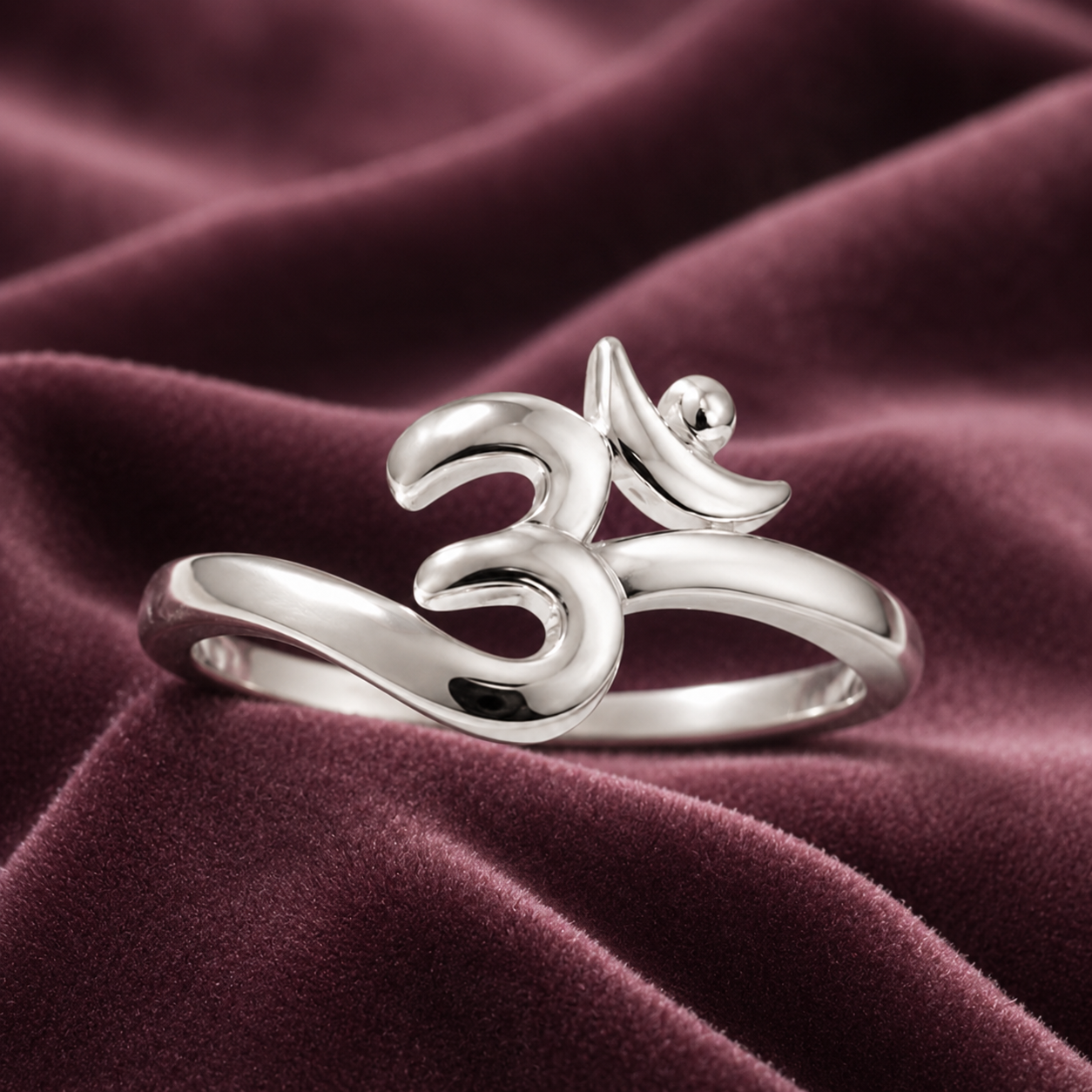 Front view 925 silver om symbol ring on burgundy velvet background spiritual awareness design