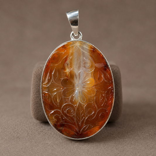 925 silver oval carved carnelian pendant with floral design on gray display