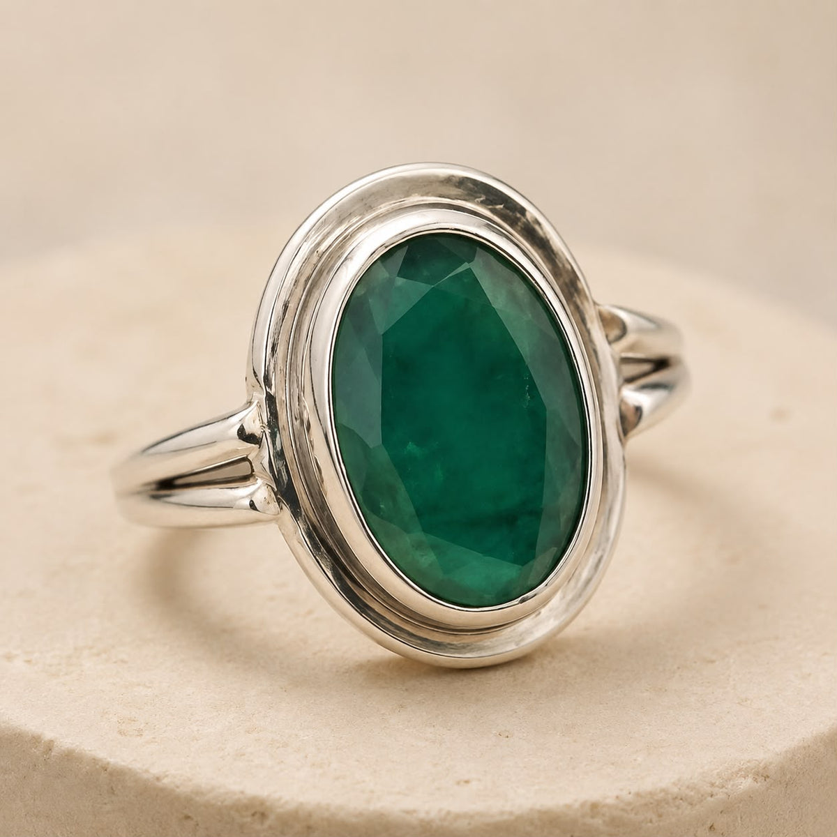 925 silver oval emerald panna ring with green gemstone cabochon, front view on neutral background