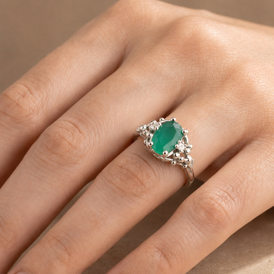 925 silver oval emerald panna ring worn on hand with ornate halo and scalloped band