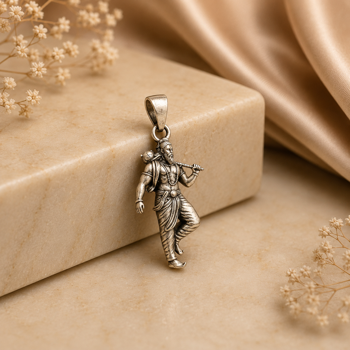 925 silver Lord Parashurama axe pendant with figure holding axe, on a beige stone block