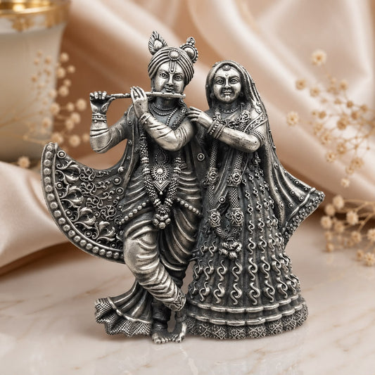 925 silver Radha Krishna pendant with detailed deity figures on marble surface