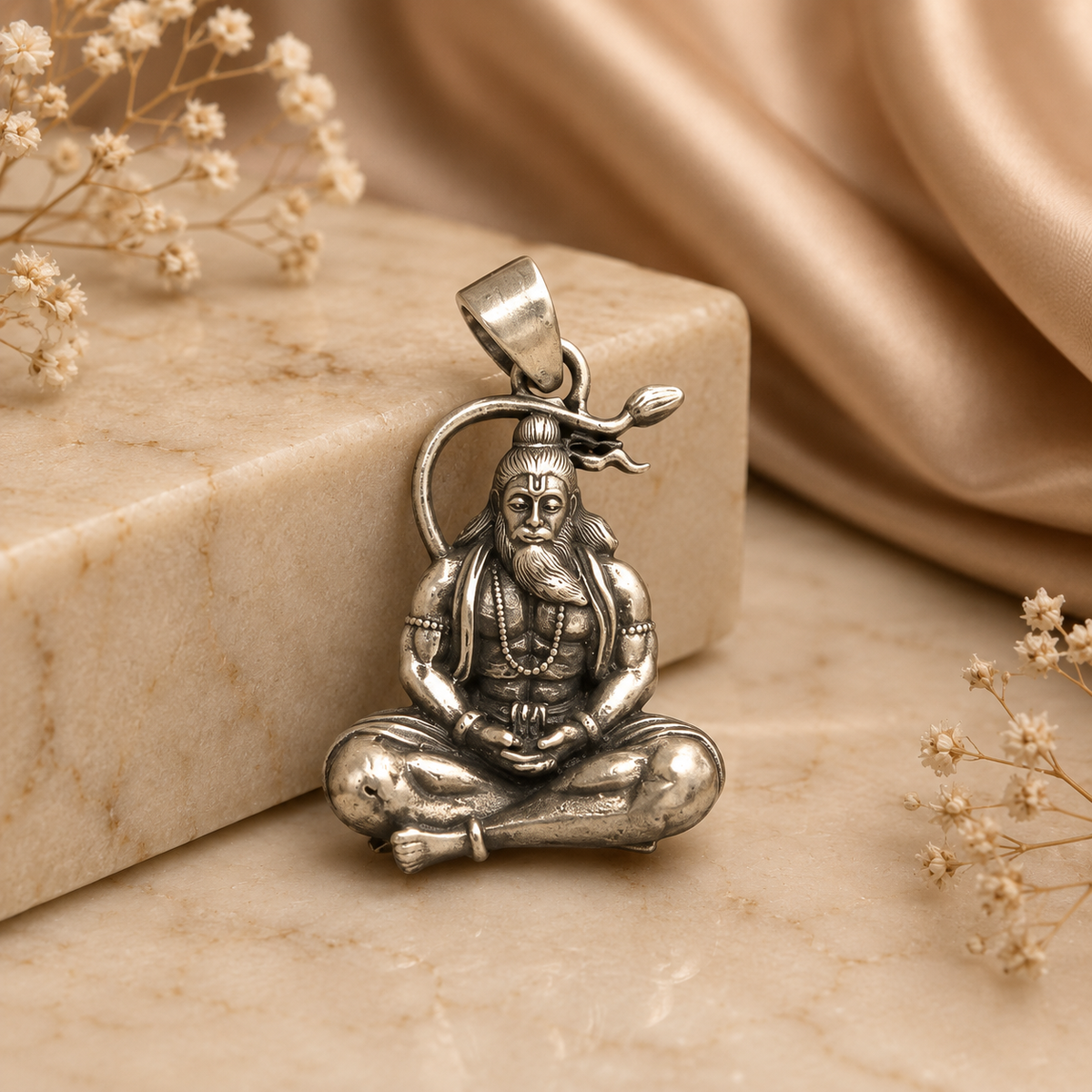 925 silver rishi muni pendant with seated sage figure on stone background