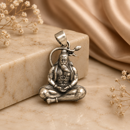 925 silver rishi muni pendant with seated sage figure on stone background