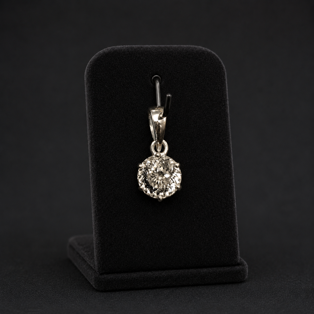 Round cubic zirconia pendant in 925 silver shown on a black jewelry display stand