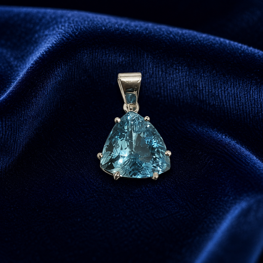 925 silver blue topaz trillion-cut pendant with bezel setting on dark blue fabric