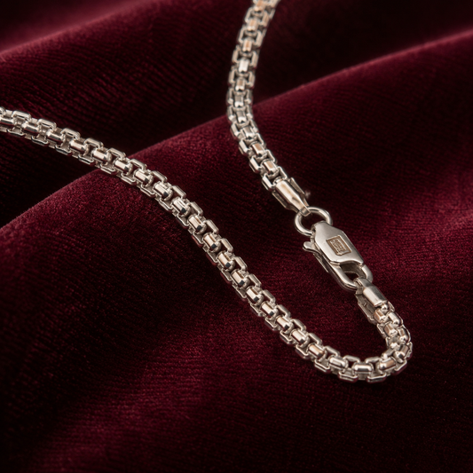 Sterling silver 925 box chain necklace with clasp and links on deep red velvet
