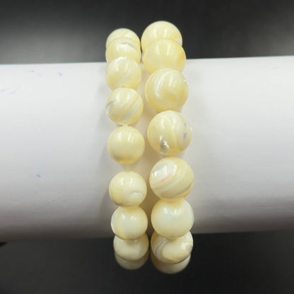 Mother of Pearl Bracelet showing polished round beads with subtle creamy and white swirls