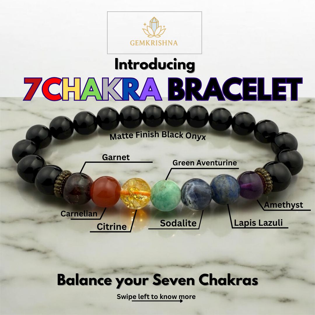 7 Chakra bracelet with labeled stones on a marble background, featuring the brand 'GemKrishna'.