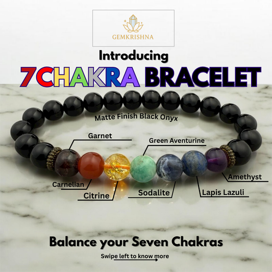 7 Chakra bracelet with labeled stones on a marble background, featuring the brand 'GemKrishna'.