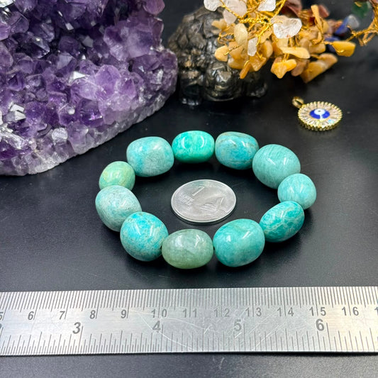 Amazonite tumble bracelet with turquoise oval beads on dark surface and ruler for scale