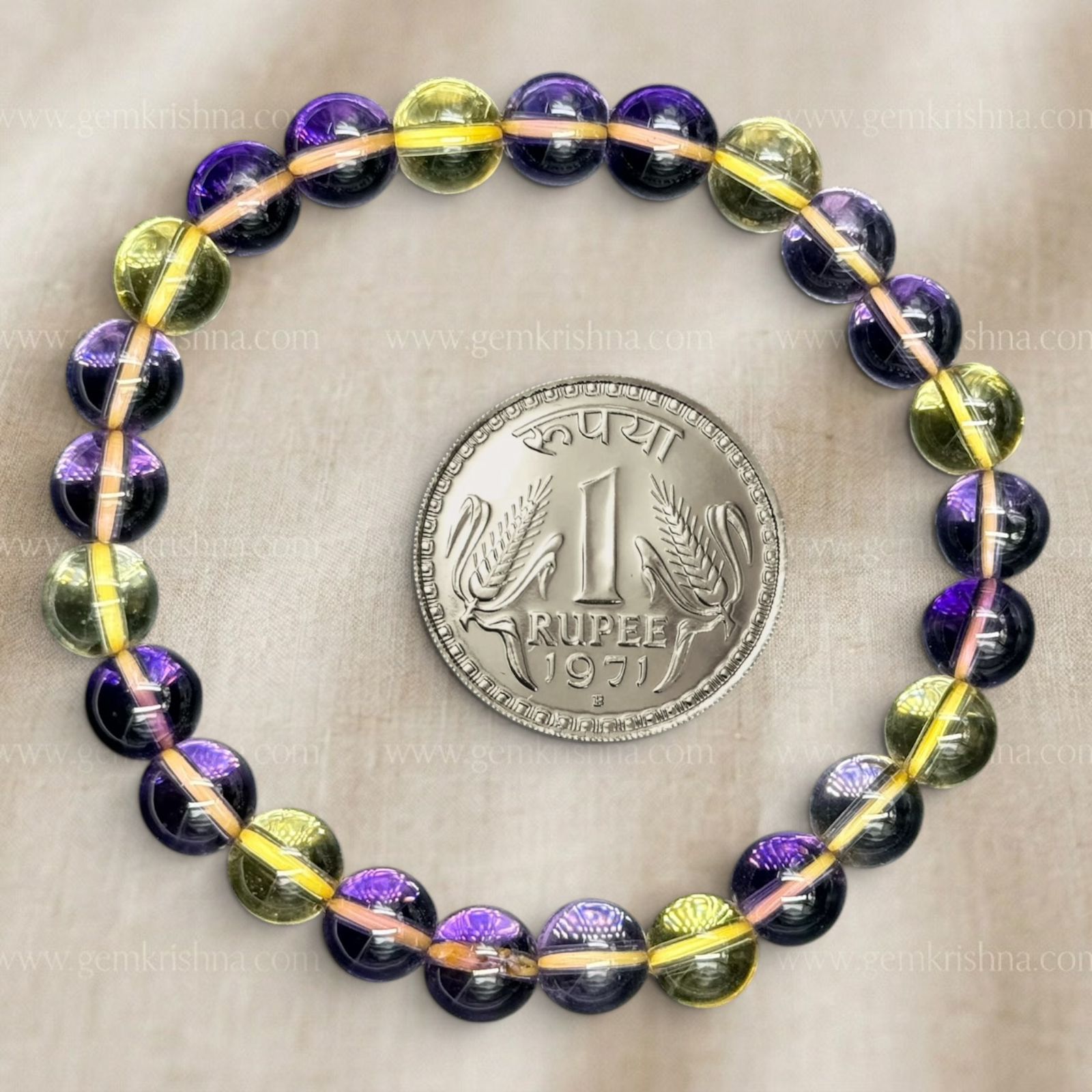 Ametrine bracelet with purple and yellow 8mm beads on a gray background