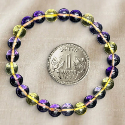 Ametrine bracelet with purple and yellow 8mm beads on a gray background