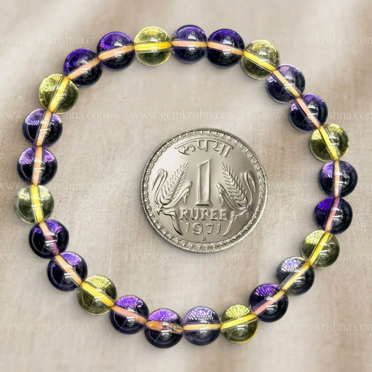 Ametrine bracelet with purple and yellow 8mm beads on a gray background