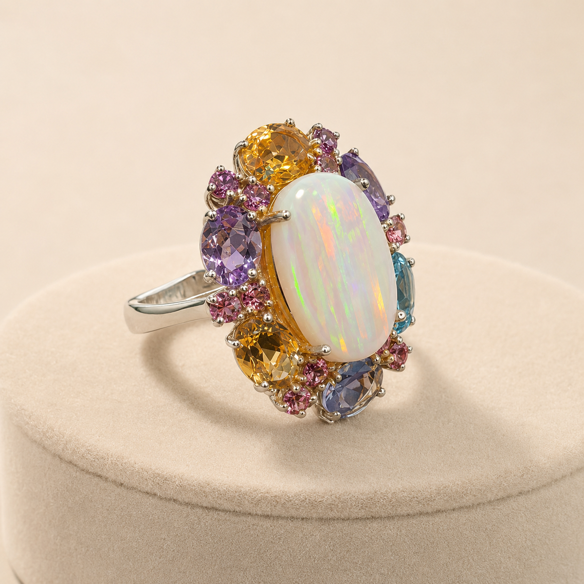 Natural opal and multi-gemstone 925 silver ring shown from angled side view on beige velvet