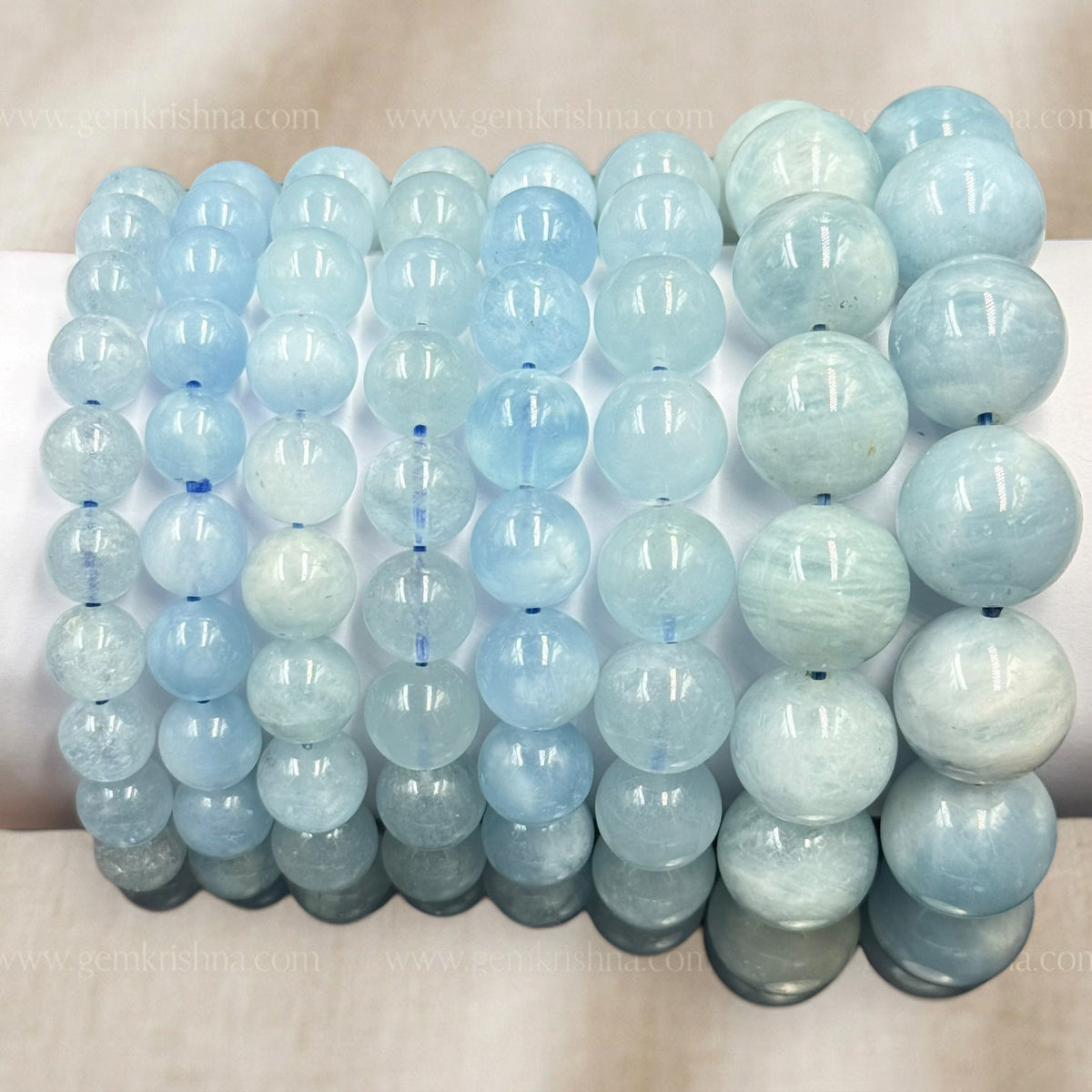 Close-up of aquamarine bracelet round beads with light blue tones and glossy finish