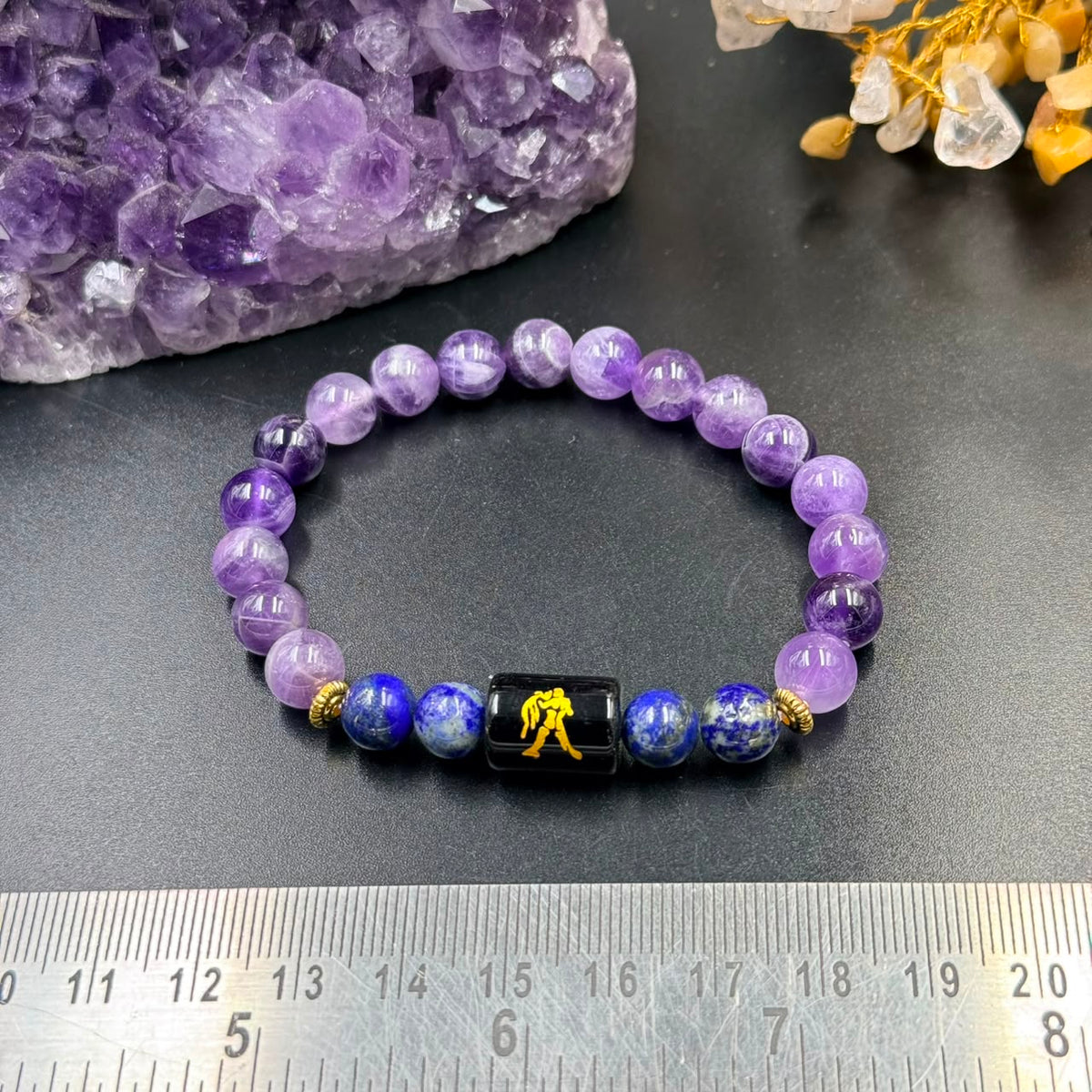 Aquarius zodiac bracelet with purple amethyst and blue lapis lazuli beads on grey background