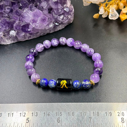 Aquarius zodiac bracelet with purple amethyst and blue lapis lazuli beads on grey background