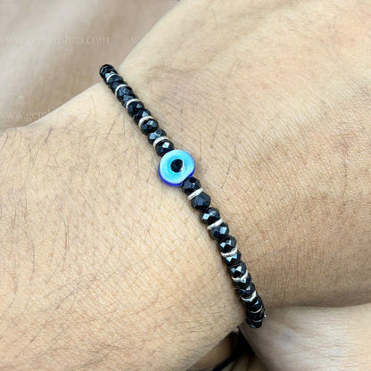 Black onyx 925 silver nazar kavach bracelet worn on wrist with blue evil eye bead