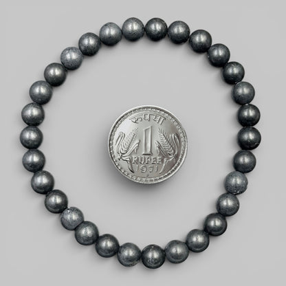 Black shungite bead bracelet with metallic dark luster round stones and coin centerpiece