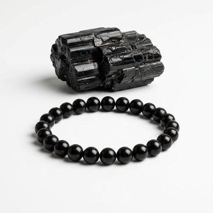 Natural black tourmaline bead bracelet with round black stones and rough black tourmaline specimen
