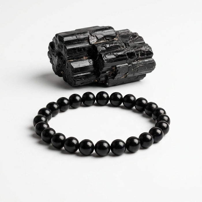 Natural black tourmaline bead bracelet with round black stones and rough black tourmaline specimen