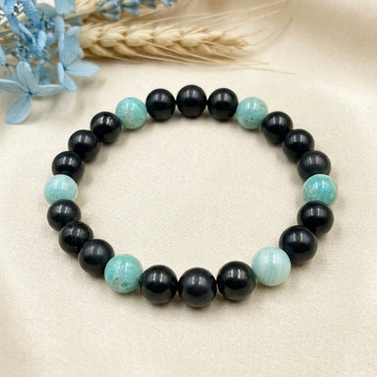 Bracelet for Communication with black round beads and light blue stone accents