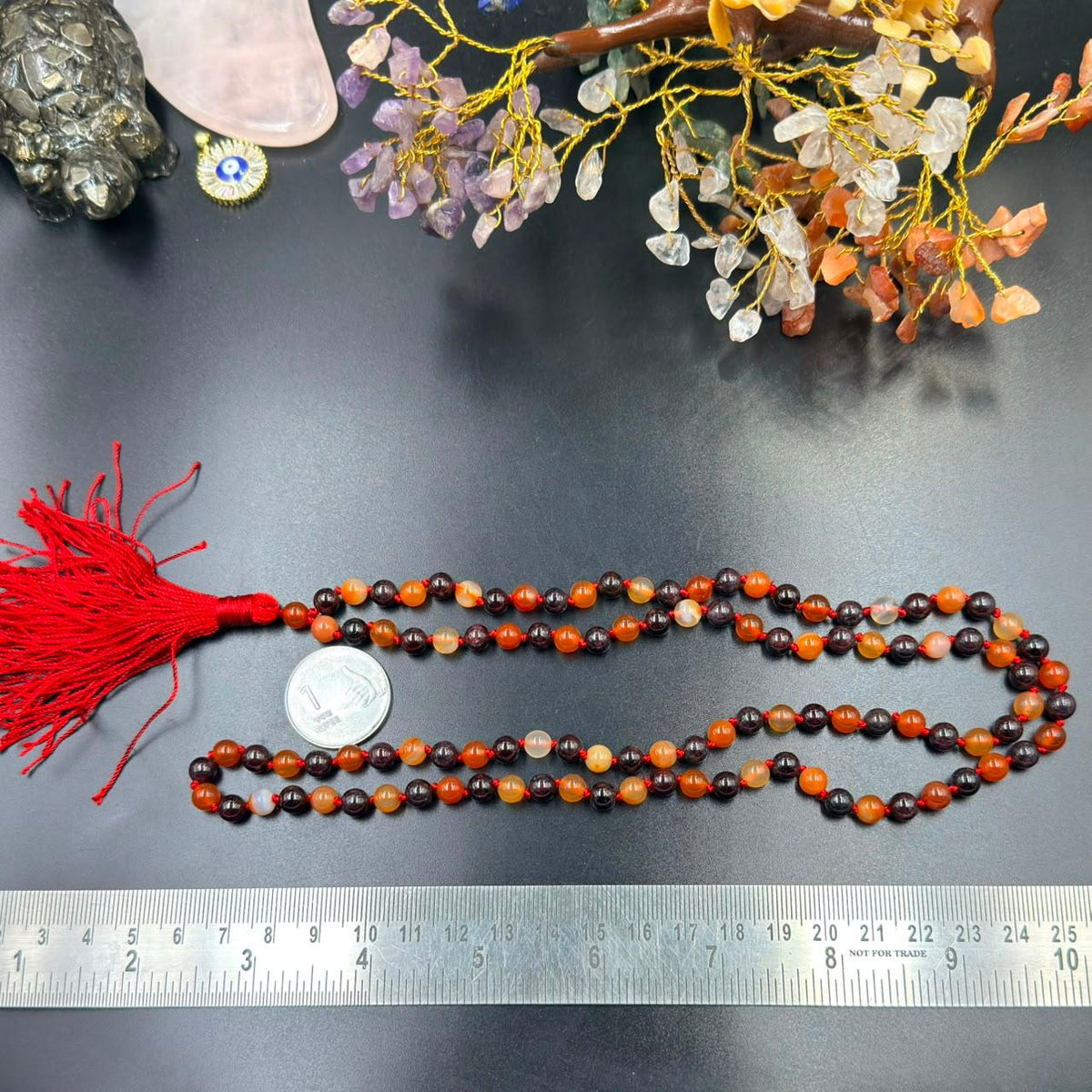 Carnelian and garnet jaap mala bead strands with red tassel and ruler for size