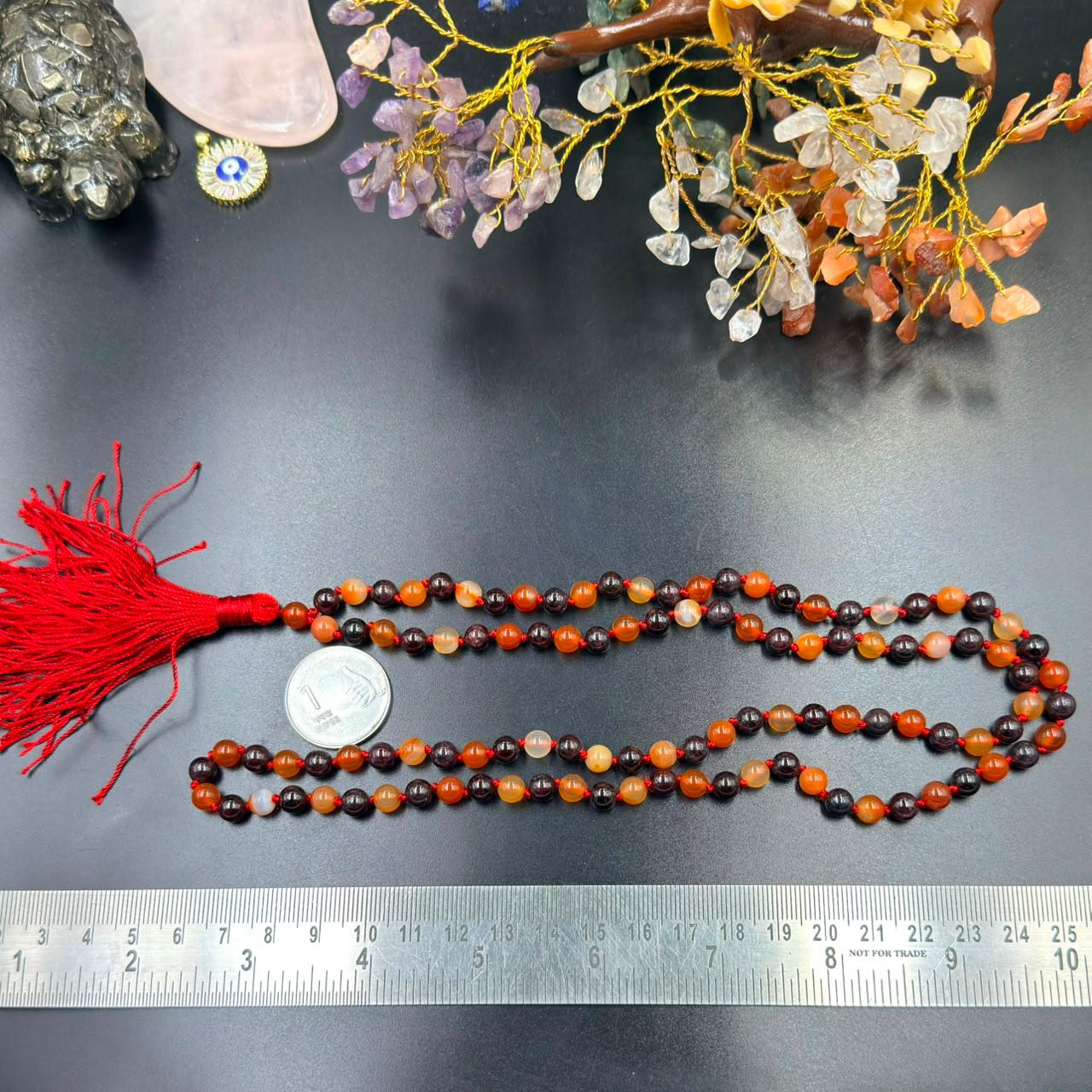 Carnelian and garnet jaap mala bead strands with red tassel and ruler for size