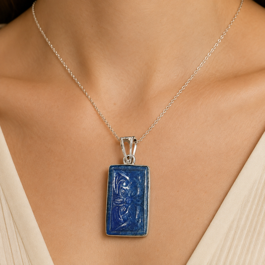 925 silver carved lapis lazuli pendant worn on a silver chain close to neckline