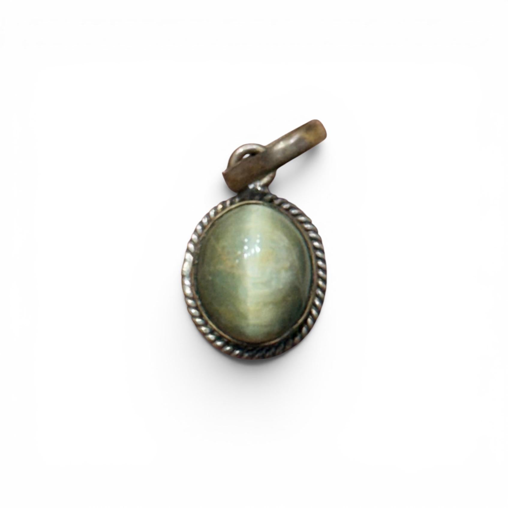 Cat’s eye pendant in oval frame with rope border and bronze-toned top bail