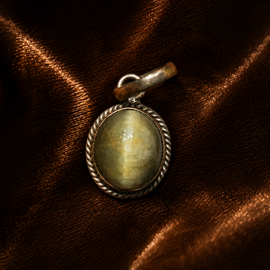 Cat’s eye pendant with oval gemstone in an antique silver rope bezel setting