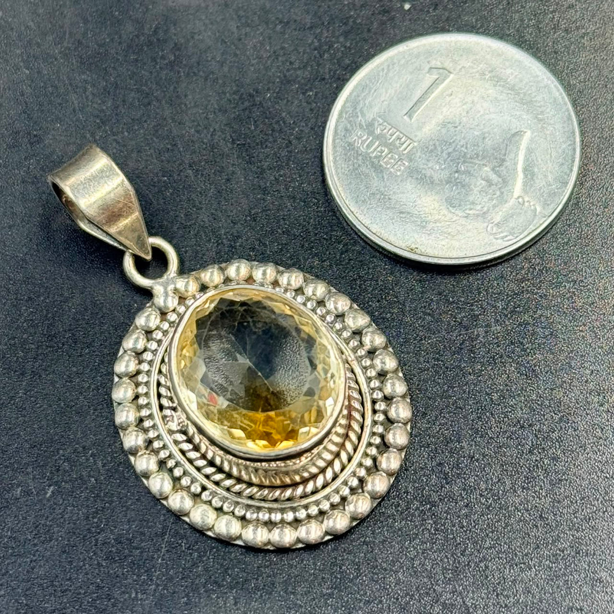 Citrine 925 silver locket pendant with oval citrine gemstone on dark textured background