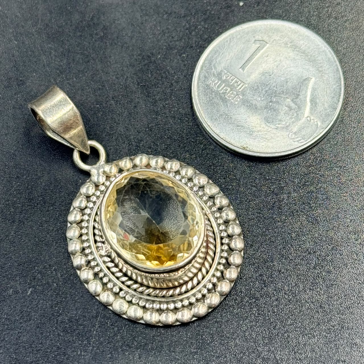 Citrine 925 silver locket pendant with oval citrine gemstone on dark textured background