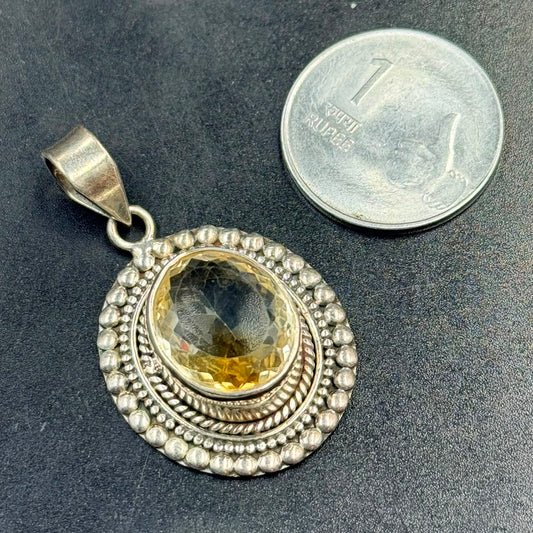 Citrine 925 silver locket pendant with oval citrine gemstone on dark textured background